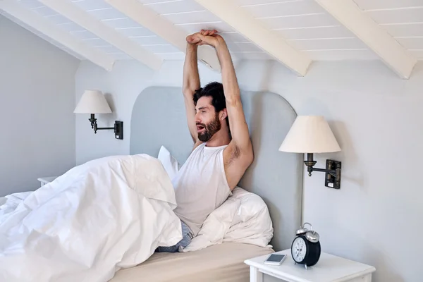 Man stretching arms after waking up — Stock Photo, Image