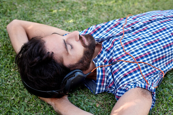 Man listening to music on grass