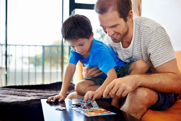 Dad and son building puzzle together — Stock Photo, Image