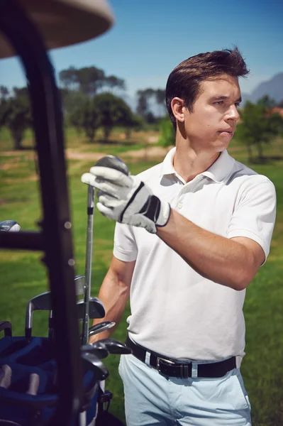 Golf man choosing correct iron club — Stock Photo, Image