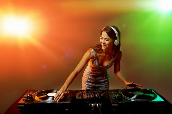 Dj woman playing music on vinyl record deck Stock Picture