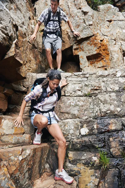 Hiking man and woman climbing Stock Image