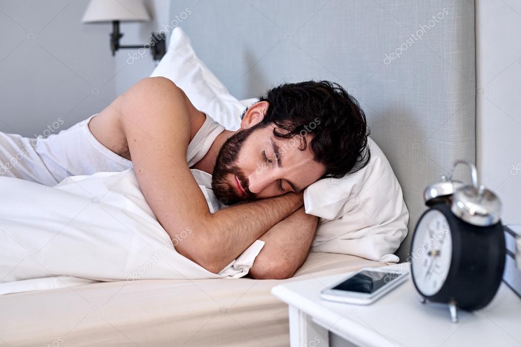 man sleeping comfortably in bed