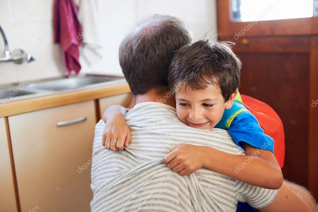Father and son hug goodbye before school