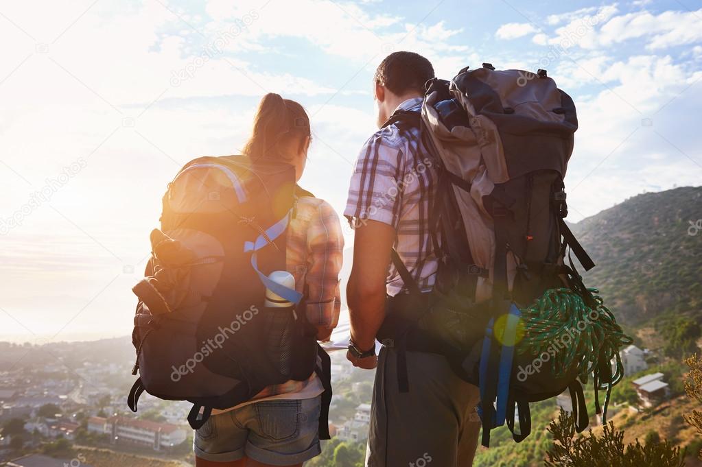 couple with backpacks on hiking trail