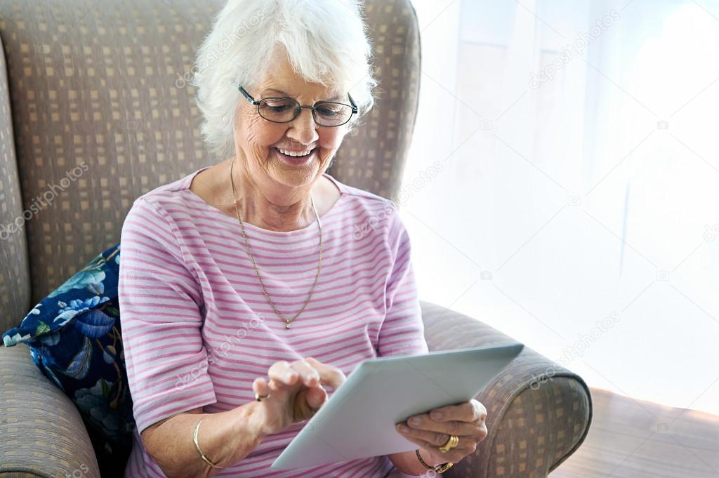 woman in couch holding touchscreen