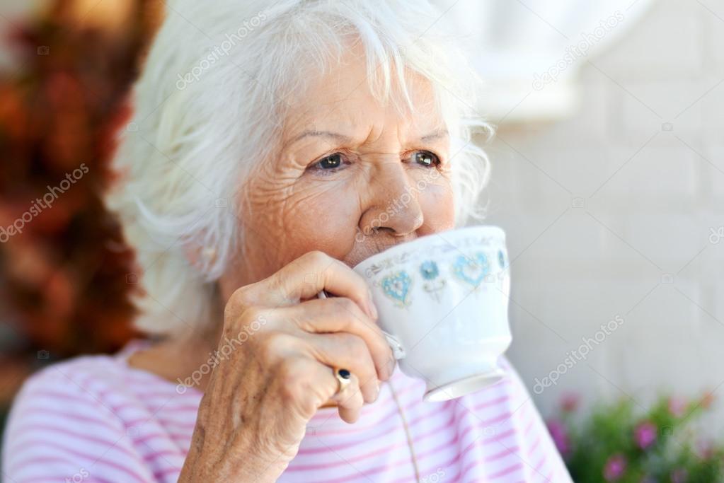 woman taking sip of tea