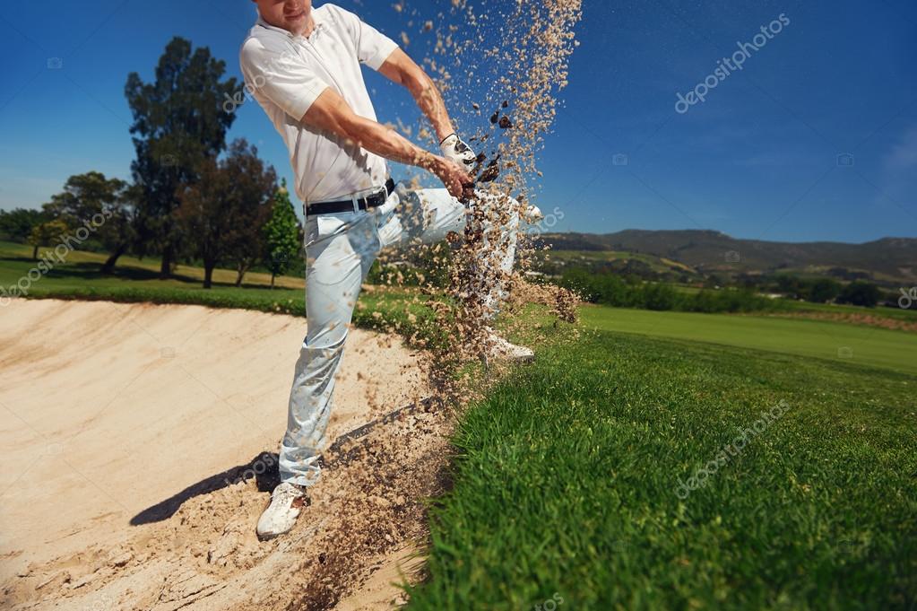 Golfer hitting ball from hazard Stock Photo by ©Daxiao_Productions 74976079