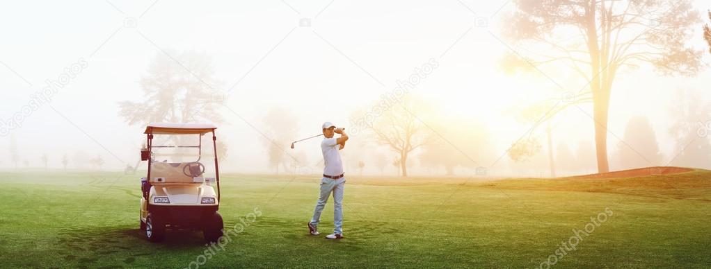 Man on early morning golf game