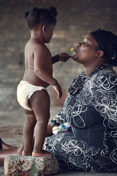 mother kissing her baby girl