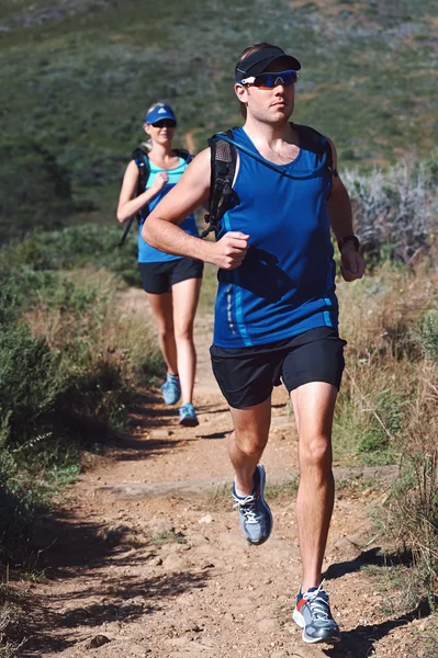 Couple trail running together for sport — Stock Photo, Image