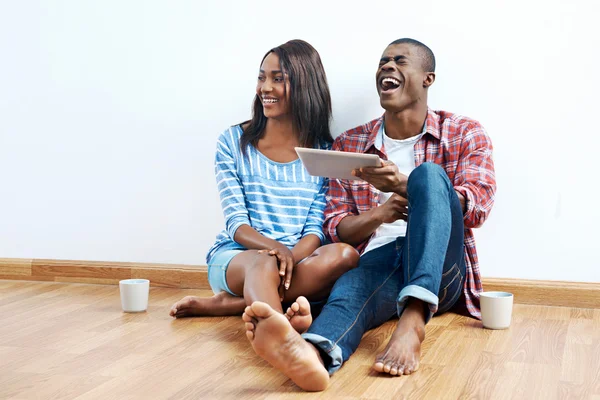 African couple looking on tablet — Stock Photo, Image