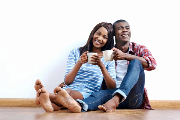 African couple on floor of new home — Stock Photo, Image