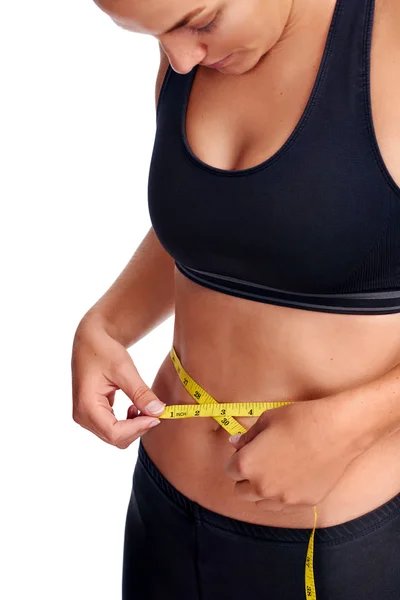 Woman taking waist measurement with tape — Stock Photo, Image