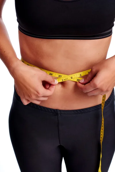 Woman taking waist measurement with tape — Stock Photo, Image