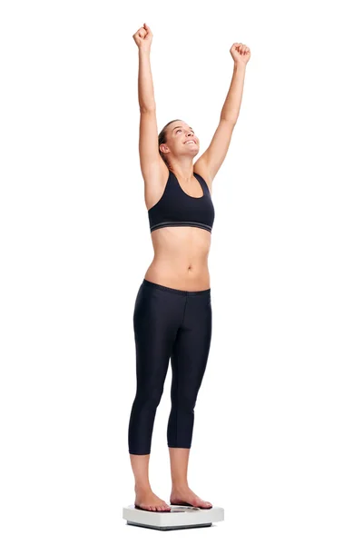 Woman standing on scale cheering — Stock Photo, Image