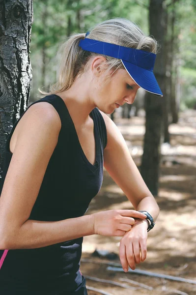 Woman checking on gps sports watch Stock Image