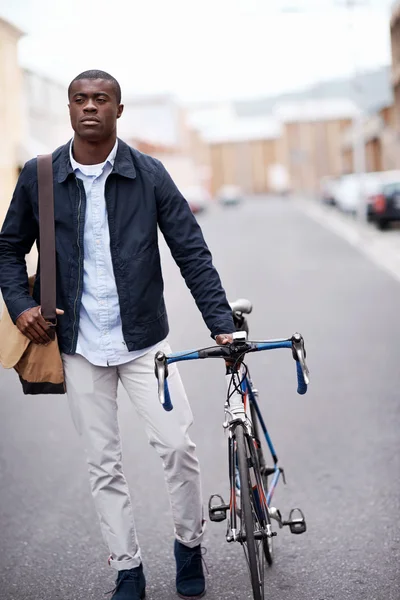 african man with bicycle walking