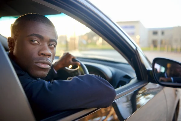 Businessman driving new car — Stock Photo, Image