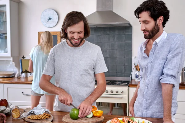 Man assisting with salad for friends — Stock Photo, Image