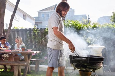 man preparing fire barbecue