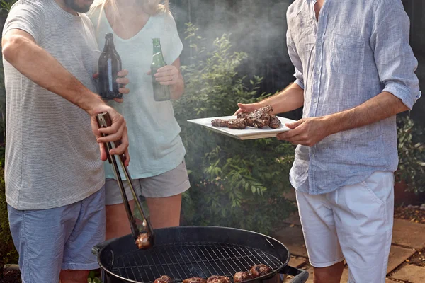 Hombre ayudando en la barbacoa de jardín — Foto de Stock