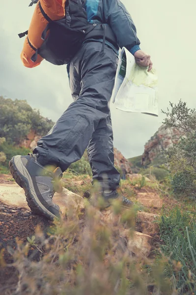 Hiker with map and backpack outdoors — Stock Photo, Image