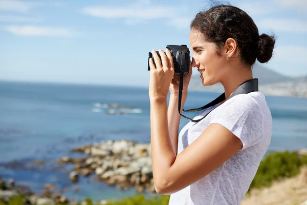 Mujer joven tomando fotos del océano — Foto de Stock