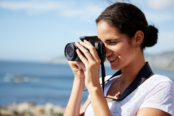 woman taking pics of the ocean