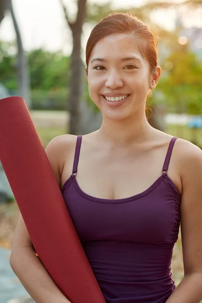 fitness lifestyle woman holding yoga mat