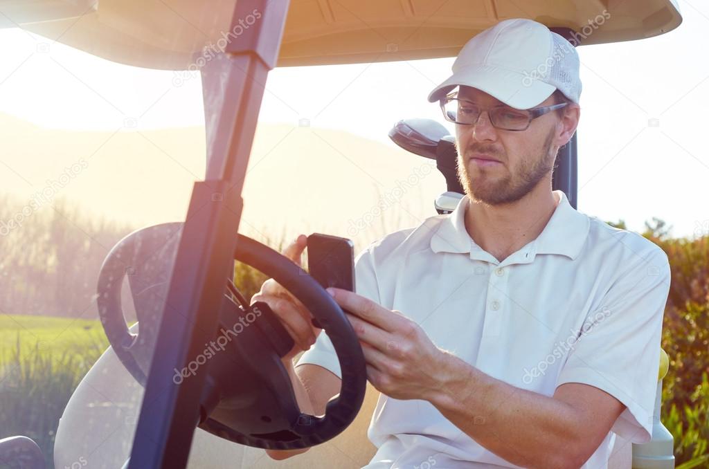 golfer using cellphone app on cart