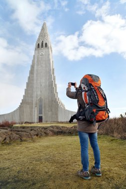 woman taking picture of church