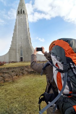 woman taking picture of church