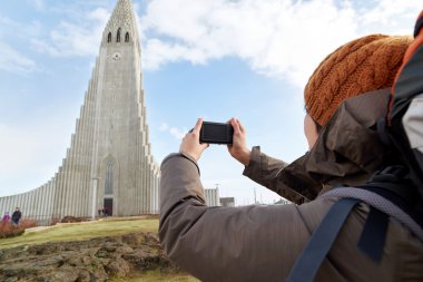 woman taking picture of church