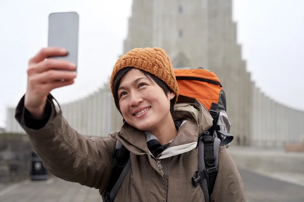 Backpacker tourist selfie with mobile phone — Stockfoto