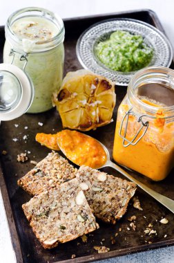 Dips and spread with seeded bread as a snack clipart