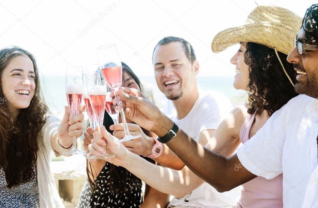 Smiling friends celebrating a special occasion with drinks