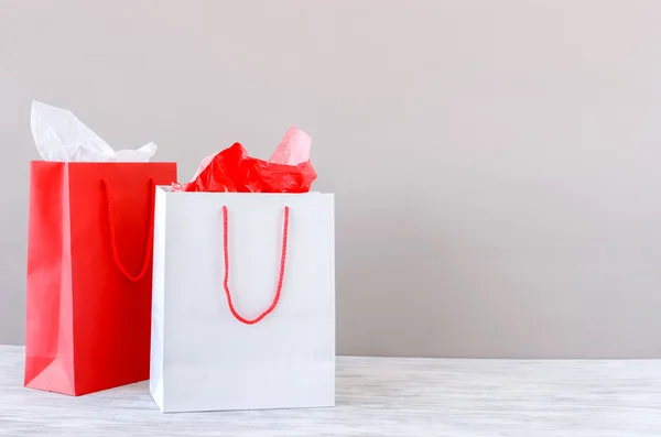 Presents on the table with paper shopping bags — Stockfoto