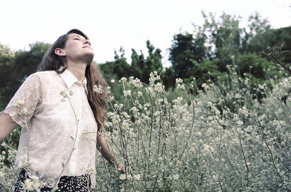 Carefree young woman experiencing freedom within nature, a styled fashion series