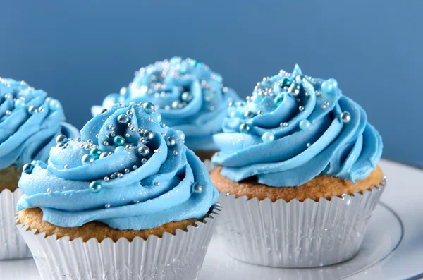 Blue cupcakes with silver decorations — Stock Photo, Image