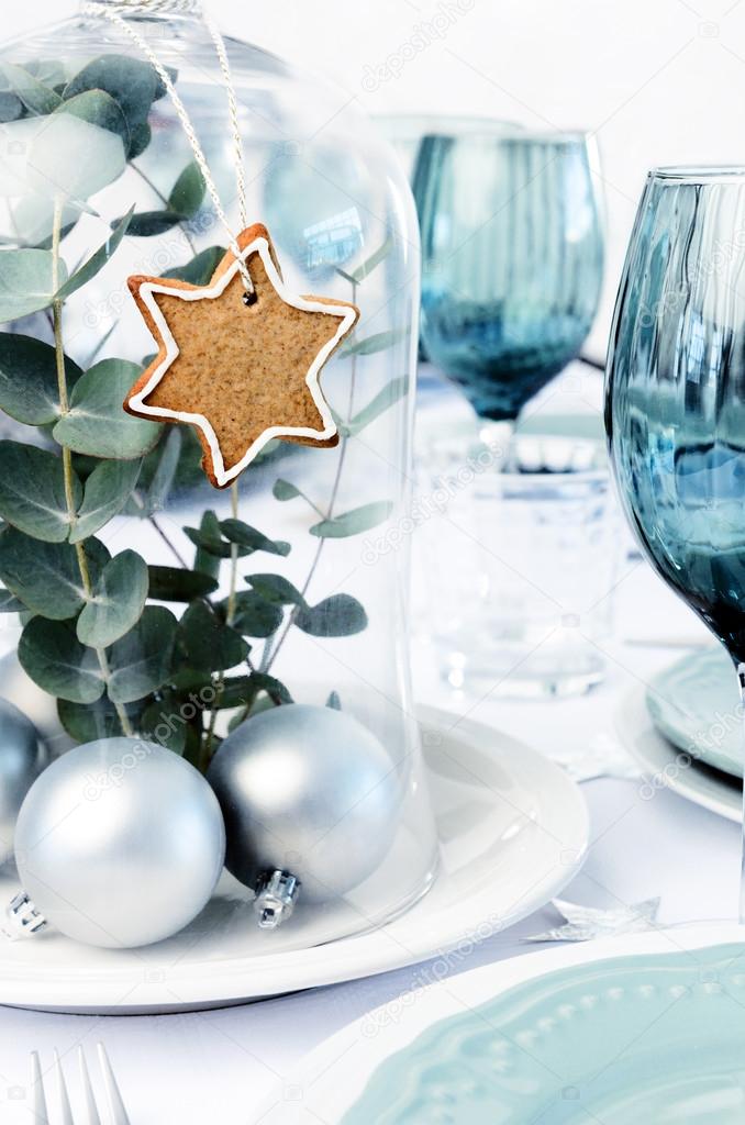 Blue christmas dinner table setting with glass dome centerpiece Stock