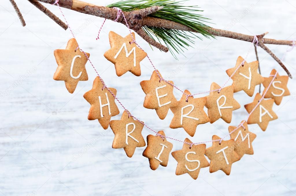 Iced gingerbread cookies hanging off a branch