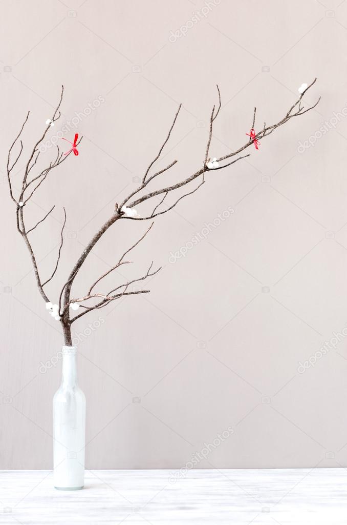 Bare branch in white vase on table top