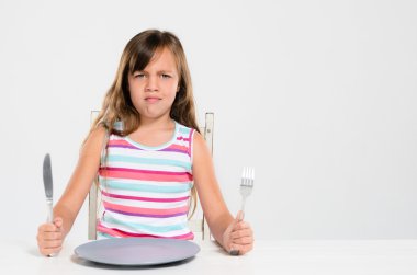 Girl refusing to eat at mealtime clipart