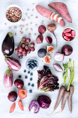 Assorted purple toned fruits and vegetables