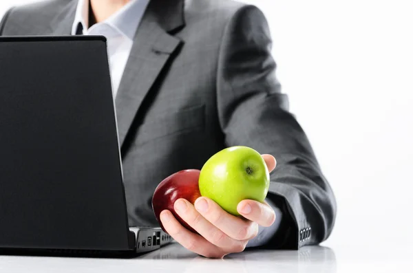 Businessman holding green and red apples — Stock Photo, Image