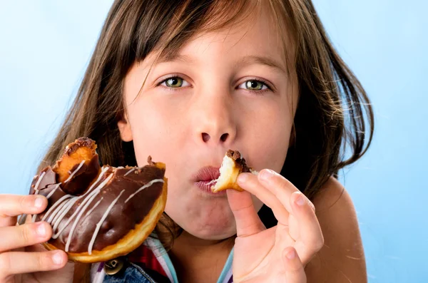 Happy kid eating a donut — Stock Photo, Image