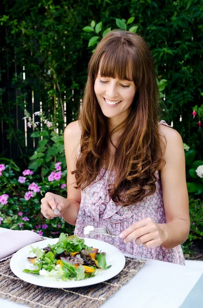 Женщина ест салат на открытом воздухе — стоковое фото