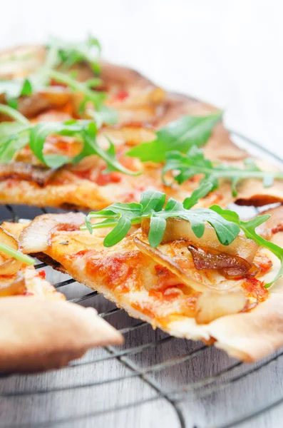 Thin crust pizza slice topped