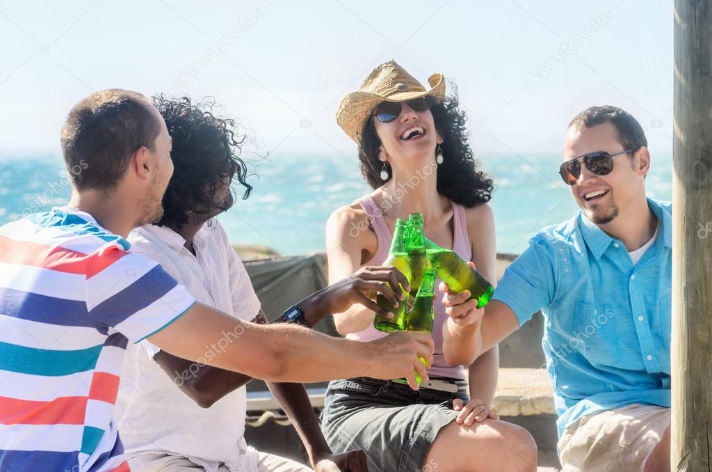 Friends at a beach party having drinks